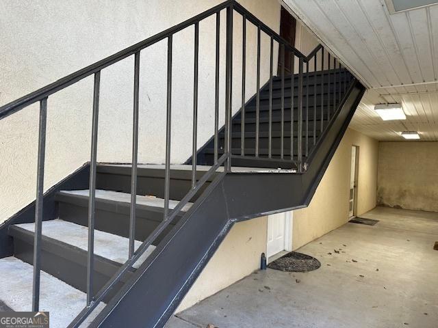 stairway featuring concrete flooring