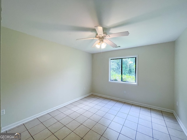 tiled spare room with ceiling fan