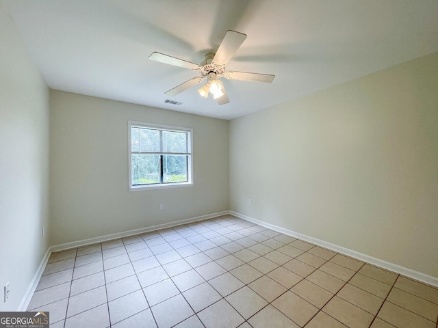 unfurnished room with ceiling fan and light tile patterned flooring