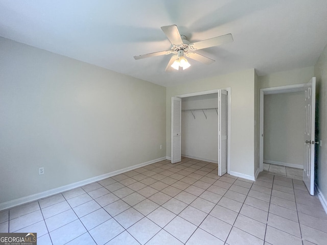 unfurnished bedroom featuring ceiling fan, a closet, and light tile patterned flooring