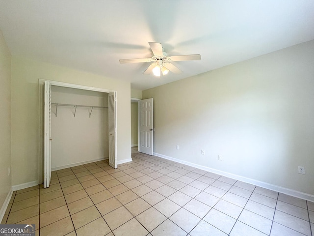 unfurnished bedroom featuring light tile patterned floors, a closet, and ceiling fan