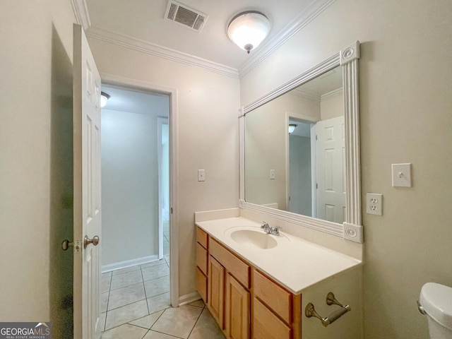 bathroom with tile patterned floors, vanity, toilet, and crown molding