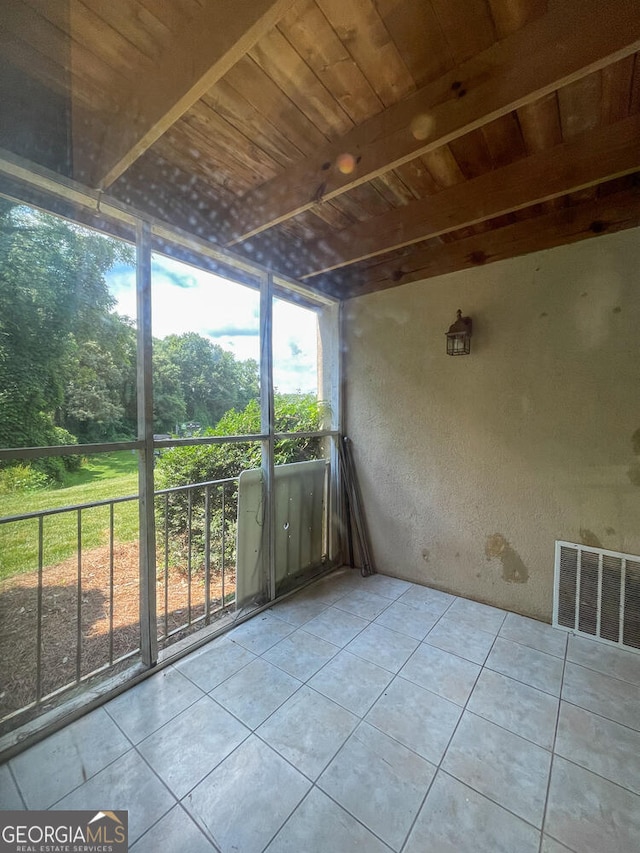 unfurnished sunroom with wooden ceiling