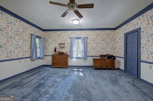 interior space featuring ornamental molding, dark carpet, and ceiling fan