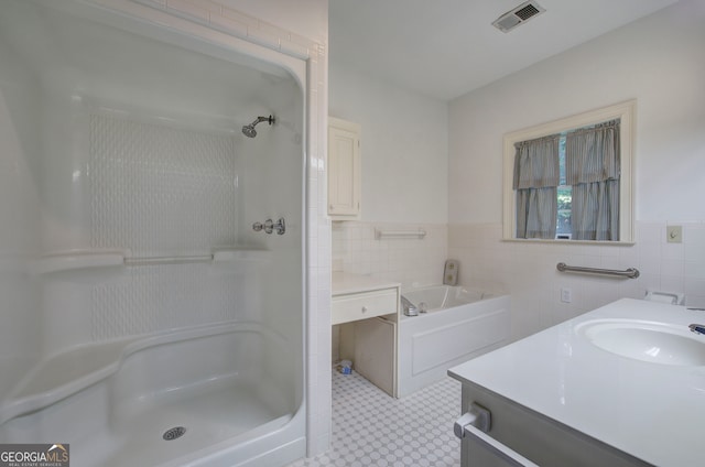 bathroom with vanity, plus walk in shower, and tile walls