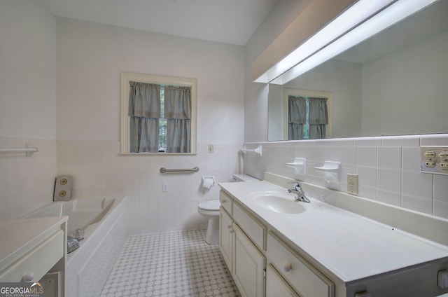 bathroom featuring vanity, toilet, tile walls, and a bath