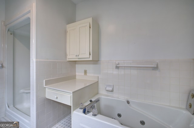 bathroom with tile walls and a tub