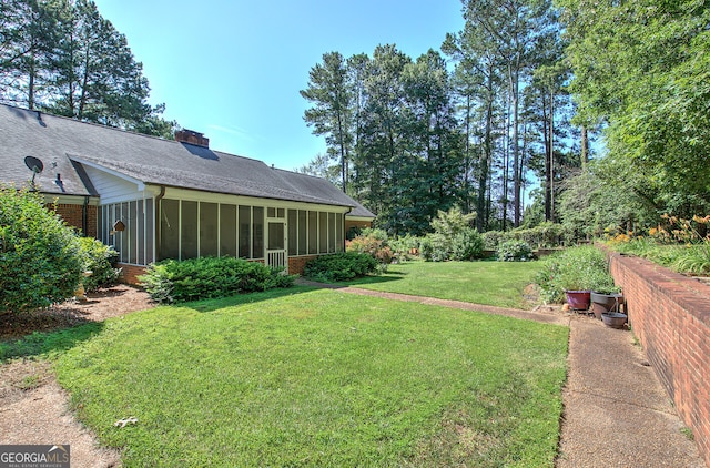 view of yard featuring a sunroom