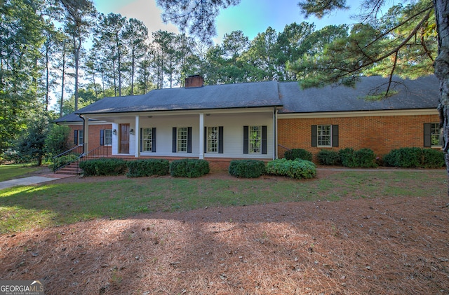 single story home with a front yard and a porch