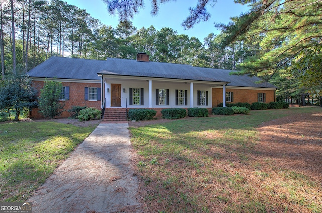 ranch-style house featuring a front yard and a porch