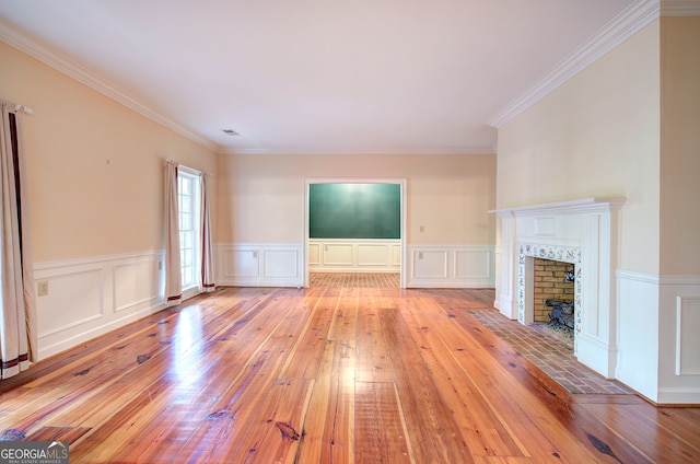 unfurnished living room featuring light hardwood / wood-style flooring and crown molding