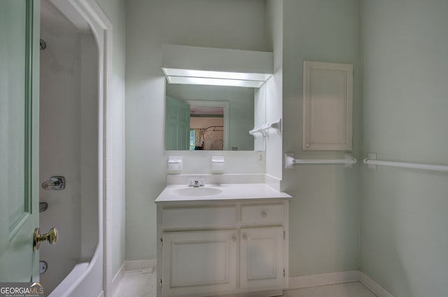 bathroom featuring vanity, shower / bathing tub combination, a skylight, and tile patterned flooring