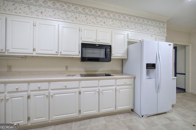 kitchen with black appliances, white cabinets, and crown molding