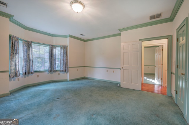 carpeted empty room with ornamental molding