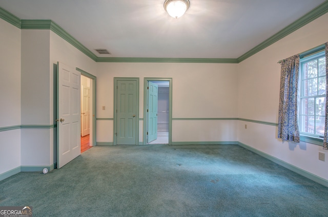 empty room with ornamental molding and carpet floors