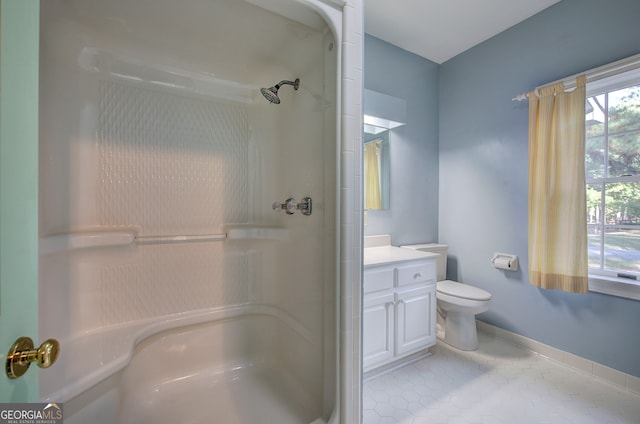 bathroom with vanity, toilet, tile patterned floors, and walk in shower