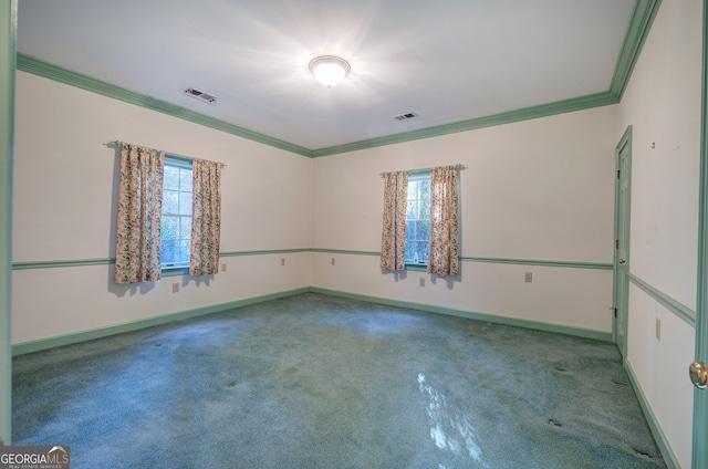 empty room with crown molding, carpet floors, and a wealth of natural light