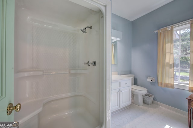 bathroom with vanity, toilet, tile patterned floors, and a shower