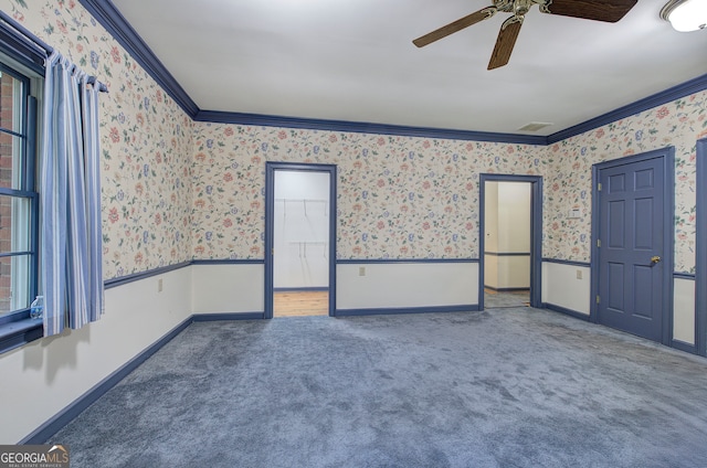 carpeted spare room with ornamental molding and ceiling fan