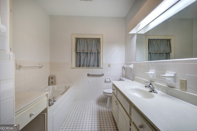 bathroom featuring toilet, a tub, vanity, and tile walls