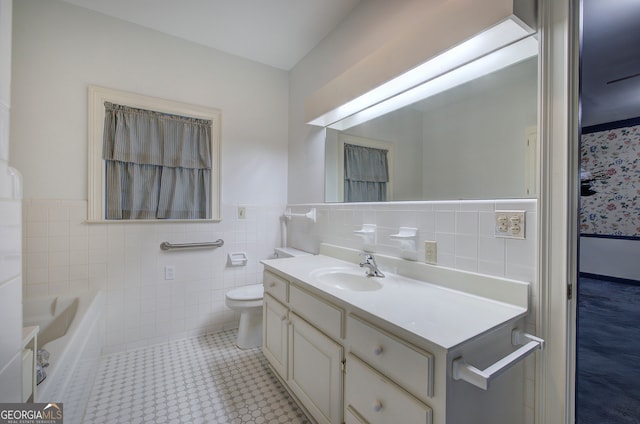 bathroom with toilet, tile patterned floors, tile walls, a bathing tub, and vanity