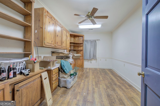 office area with crown molding, wood-type flooring, and ceiling fan