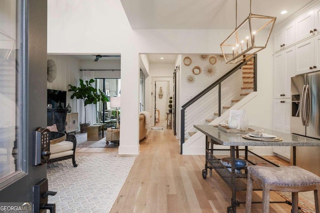 foyer with an inviting chandelier and light hardwood / wood-style flooring