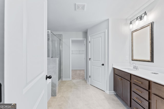 bathroom with tile patterned flooring, vanity, and an enclosed shower