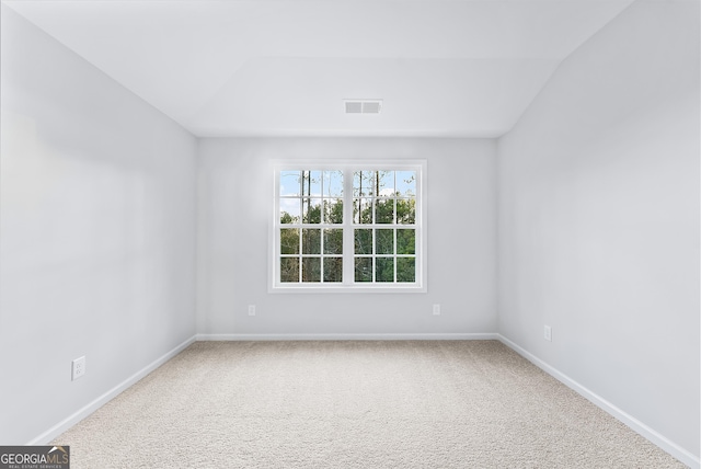 empty room with carpet and lofted ceiling