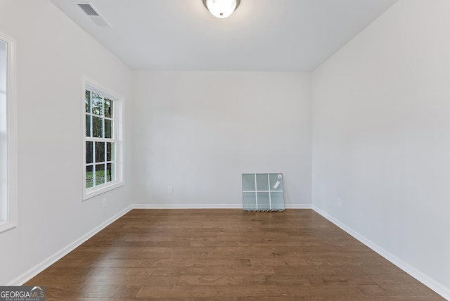 unfurnished room with dark hardwood / wood-style floors and a wealth of natural light