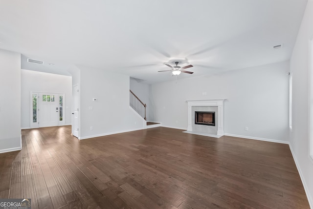 unfurnished living room featuring ceiling fan, dark hardwood / wood-style flooring, and a high end fireplace