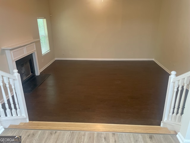 unfurnished living room featuring hardwood / wood-style flooring