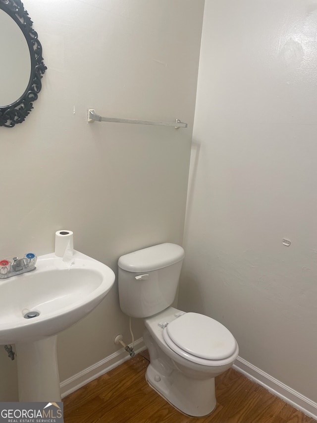 bathroom featuring hardwood / wood-style flooring and toilet