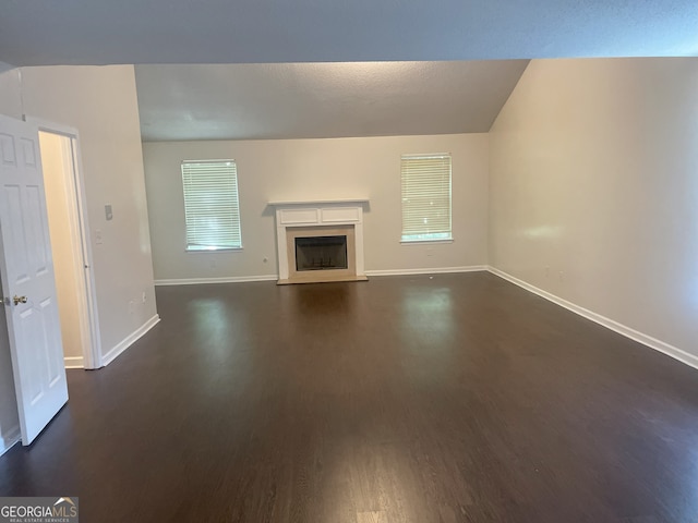 unfurnished living room featuring dark hardwood / wood-style floors