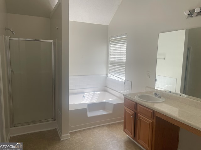 bathroom featuring vanity, lofted ceiling, plus walk in shower, and a textured ceiling