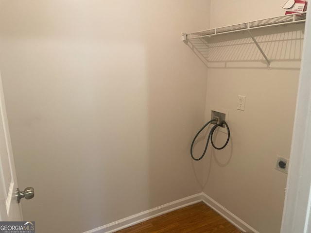 laundry area with washer hookup, electric dryer hookup, and dark hardwood / wood-style flooring