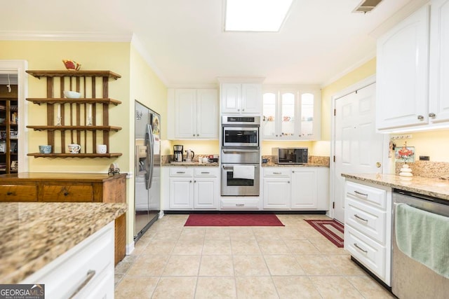 kitchen featuring appliances with stainless steel finishes, crown molding, light stone counters, and white cabinets