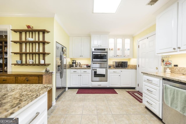 101 Huntington Dr, Dublin, GA 31021 - kitchen with stainless steel appliances, ornamental molding, a warming drawer, open shelves, and white cabinetry