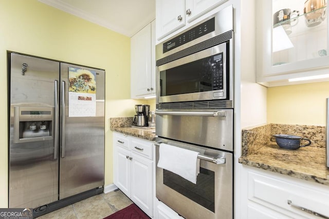 101 Huntington Dr, Dublin, GA 31021 - kitchen featuring appliances with stainless steel finishes, light stone counters, and white cabinetry