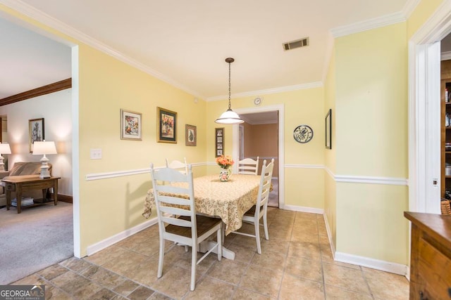 dining room featuring light colored carpet and crown molding