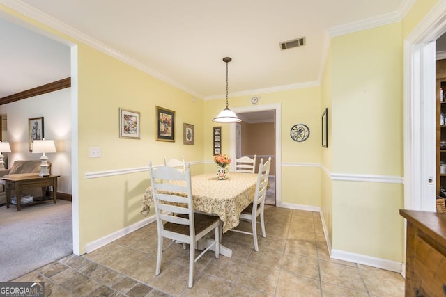 101 Huntington Dr, Dublin, GA 31021 - dining room featuring visible vents, baseboards, light tile patterned floors, crown molding, and light colored carpet