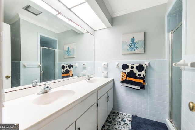 bathroom featuring vanity, tile walls, tile patterned floors, an enclosed shower, and ornamental molding