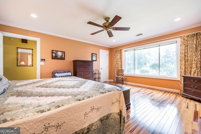 bedroom featuring ceiling fan, light hardwood / wood-style flooring, and crown molding