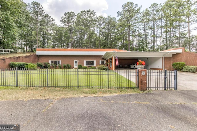 ranch-style home featuring a carport and a front yard