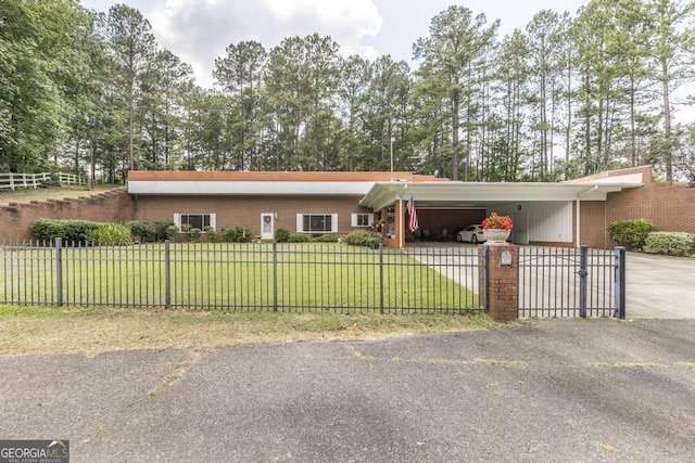 101 Huntington Dr, Dublin, GA 31021 - view of front of house featuring an attached carport, a front yard, driveway, and a fenced front yard