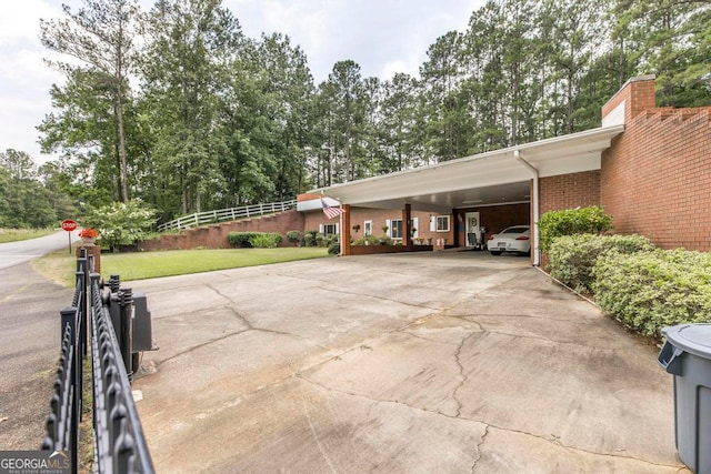 view of parking featuring a yard and a carport