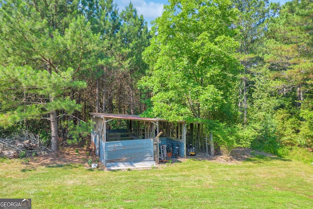 view of outbuilding with a yard