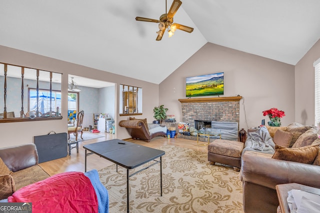 living room with ceiling fan, light hardwood / wood-style floors, lofted ceiling, and a fireplace