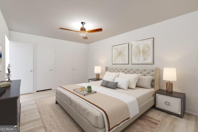 bedroom with light hardwood / wood-style flooring and ceiling fan