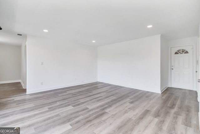 unfurnished room with light hardwood / wood-style floors